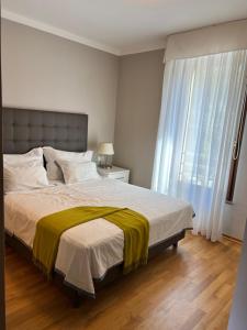 a bedroom with a large bed and a window at Pine Resort by Residence in Strožanac