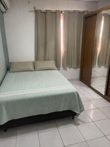 a bedroom with a bed in a room at Casa in Petrolina +7 photos