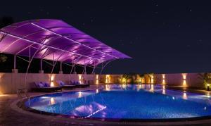 a swimming pool at night with a purple lighting at Nepalirika Hotel Biratchowk in Haraincha