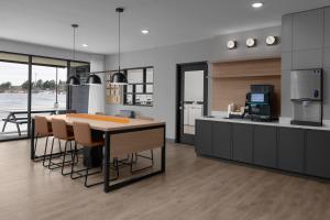 a kitchen with a table and some chairs in it at StudioRes by Marriott Denver Tech Center in Centennial