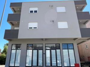 a building with large windows on the front of it at Apartment LANA in Čapljina