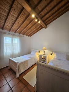 a bedroom with a bed and a table with a tv at Casa da Uva-Mosteiros Vineyards House-Heated swimming-pool in Mosteiros +43 photos
