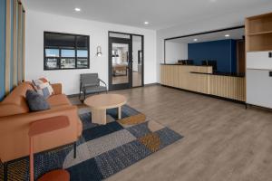a living room with a couch and a table at StudioRes by Marriott Denver Tech Center in Centennial