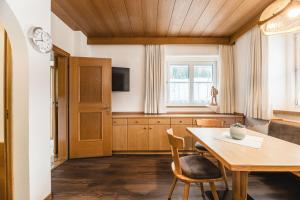 a dining room with a table and a tv at Apartments Chalet Zirm in Santa Cristina Gherdëina