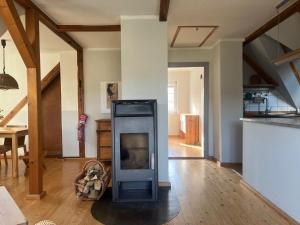 a living room with a fireplace in the middle at Haus Prälank in Neustrelitz +11 photos