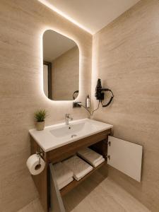 a bathroom with a sink and a mirror at Lumiera Suites Hotel in Nilüfer +56 photos