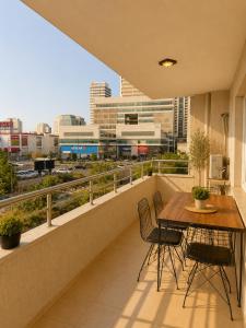 a balcony with a table and chairs and a city at Lumiera Suites Hotel in Nilüfer