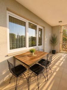 a dining room with a wooden table and chairs at Lumiera Suites Hotel in Nilüfer