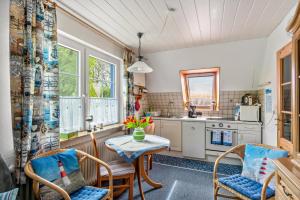 a kitchen with a table and chairs and a sink at An't Fischerspad in Wangerland