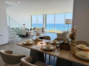 a dining room with a table with a view of the ocean at Atlantis Malibu by Carrington in Kyrenia
