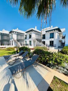 a large white building with chairs in front of it at Atlantis Malibu by Carrington in Kyrenia
