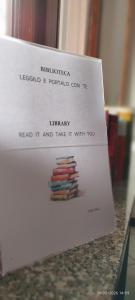 a sign that says library read it and take it with you at Casa GALLI Como in Colverde