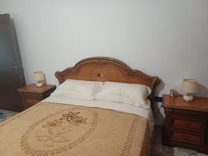 a bedroom with a large bed with two night stands at A casa di Nonna in Gambassi Terme