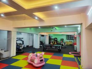 a living room with a gym with a pink toy at Nirvana Stay & Gaming Zone in Bhadarwāh