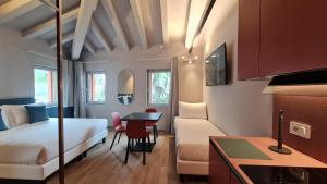 a hotel room with a bed and a table at Michelangelo House, your personal Studio in Mestre