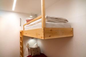 a wooden bunk bed in a room at Casa Calmea in Arosa +5 photos