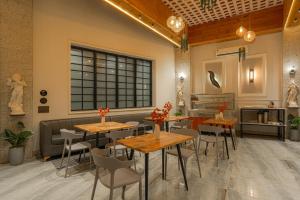 a restaurant with tables and chairs and a window at The Leaf in Ludhiana