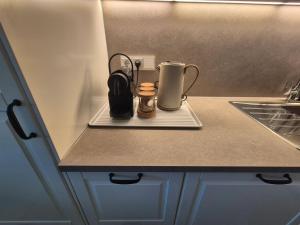 a kitchen counter with a coffee maker on a tray at MareTime - inkl Wäschepakete, 50m zum Strand in Pelzerhaken +27 photos