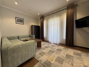 a living room with a couch and a table at Karvon Plaza Hotel in Samarkand