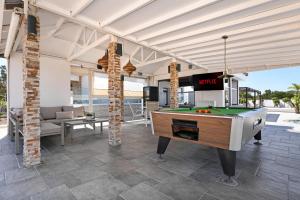 an outdoor entertaining area with a pool table at Cape Serenity Mansion in Ayia Napa +45 photos