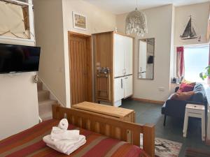 a small room with a bed and a living room at Zion Place in Dartmouth