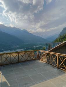 a balcony with a view of the mountains at Pachamama Hotels- Vashisht in Manāli