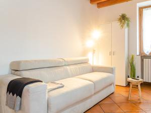 a living room with a white couch and a table at White Nest - Lake Como & Ski Area in Ballabio