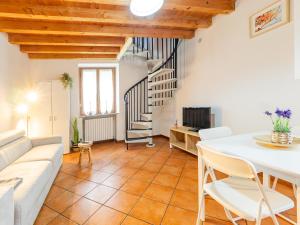 a living room with a white couch and a staircase at White Nest - Lake Como & Ski Area in Ballabio