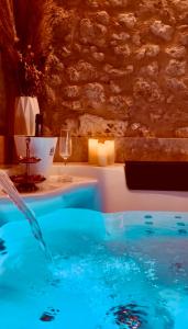 a swimming pool with a glass of wine in a room at Clos des Voluptés in Fargues-Saint-Hilaire