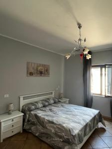 a bedroom with a bed and a window at Bed and Breakfast Medaglia D'oro in Marcianise