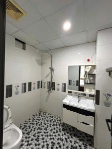 a bathroom with a sink and a toilet at Sam Son Golden Dream Hotel in Sầm Sơn