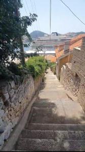 a stone path with a cruise ship in the background at Main Bus Terminal Rooms in Dubrovnik