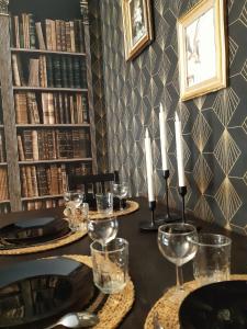 a table with wine glasses and candles on it at Bat'Appart -DIJON- Balnéo-insolite-parking gratuit in Longvic