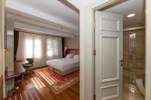 a bedroom with a bed and a bathroom at Blue Gilroy Hotel in Istanbul +124 photos