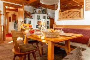 a wooden table with a basket of fruit on it at Franzerhof in Mittersill