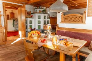 a wooden table with a basket of fruit on it at Franzerhof in Mittersill +20 photos
