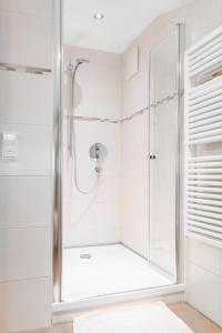 a shower with a glass door in a bathroom at Franzerhof in Mittersill