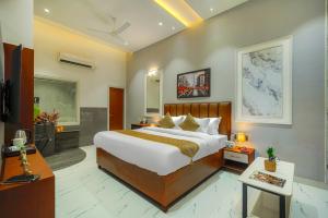 a bedroom with a large bed and a television at The Leaf in Ludhiana +92 photos