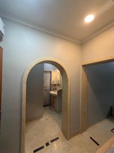 an archway in a room with a kitchen at The Highstreet Stay in Pune