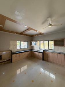 an empty kitchen with a ceiling fan in a room at The Highstreet Stay in Pune