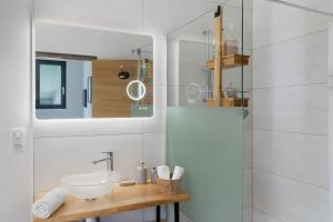 a white bathroom with a sink and a shower at Au Cerf Blanc Suite Parentale in Les Eyzies-de-Tayac +16 photos