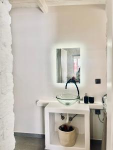 a white bathroom with a sink and a mirror at Anna home Elafonisos in Elafonisos