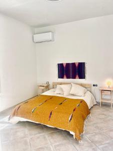 a bedroom with a large bed with a yellow blanket at Anna home Elafonisos in Elafonisos