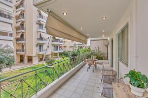 an apartment balcony with chairs and a table at Moschato-Niarchos modern apartment in Piraeus