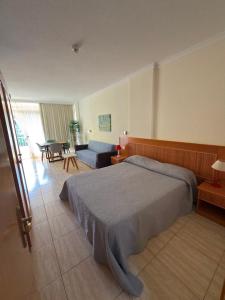 a bedroom with a bed and a living room at El Estudio de Johanna in Puerto de la Cruz +11 photos