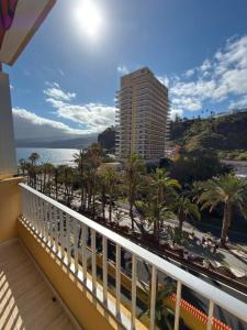 a balcony with a view of the ocean and a building at El Estudio de Johanna in Puerto de la Cruz