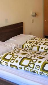 two beds in a bedroom with a bedspread on top at Corner Hostel in Sliema
