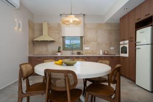 a kitchen with a white table and some chairs at Vedema Homes in Lefkogeia +93 photos