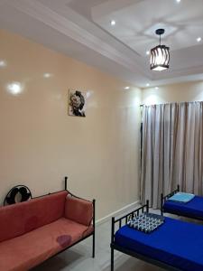 a living room with two beds and a couch at La paix bis in Saint-Louis