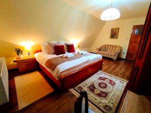 a bedroom with a large bed and a couch at Leśny Poranek in Iwkowa